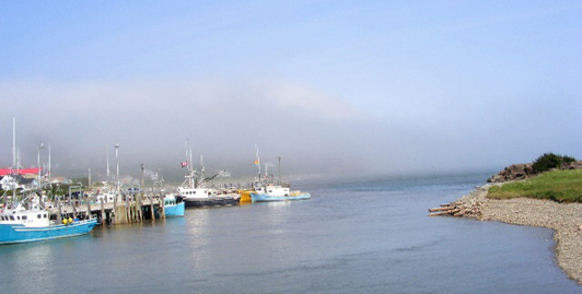 The fog is lifting at Alma's wharf in the early morning